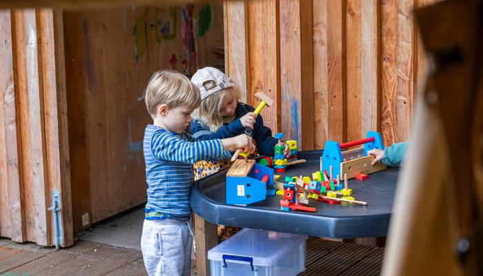 2 children playing with building blocks