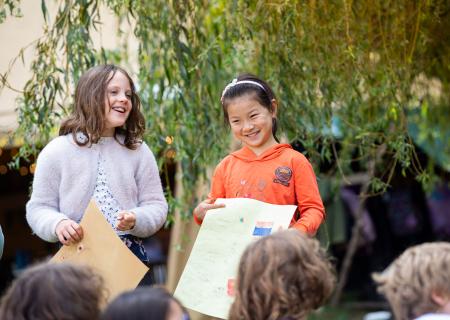 2 students presenting project outdoors