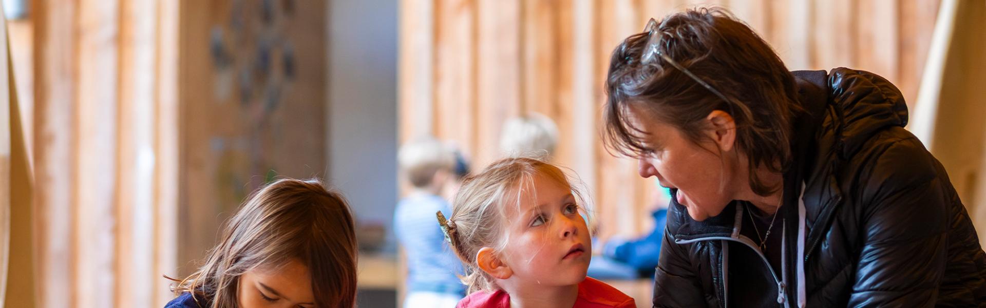 Student and teacher talking at art table