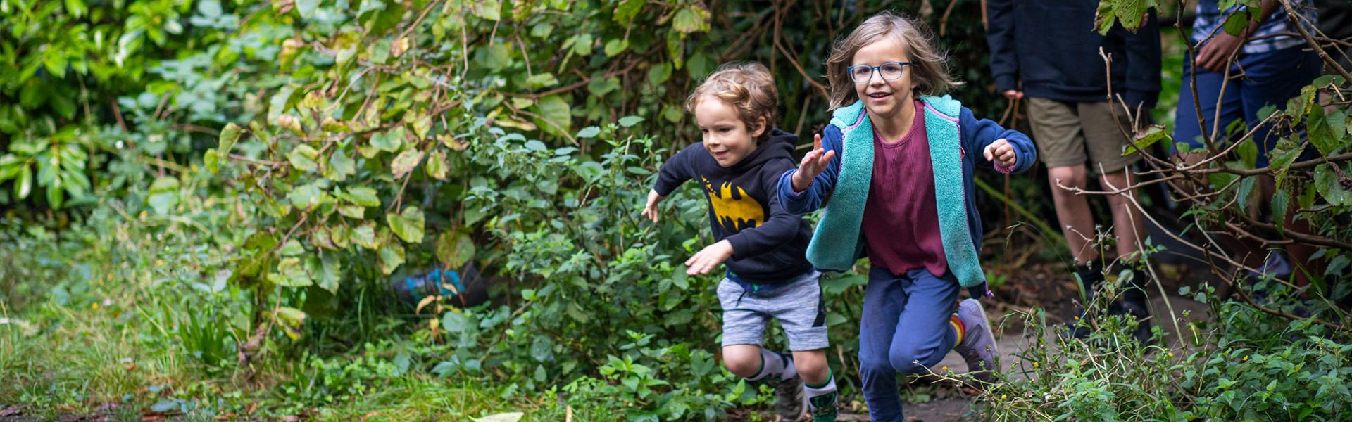 Primary students running in woods