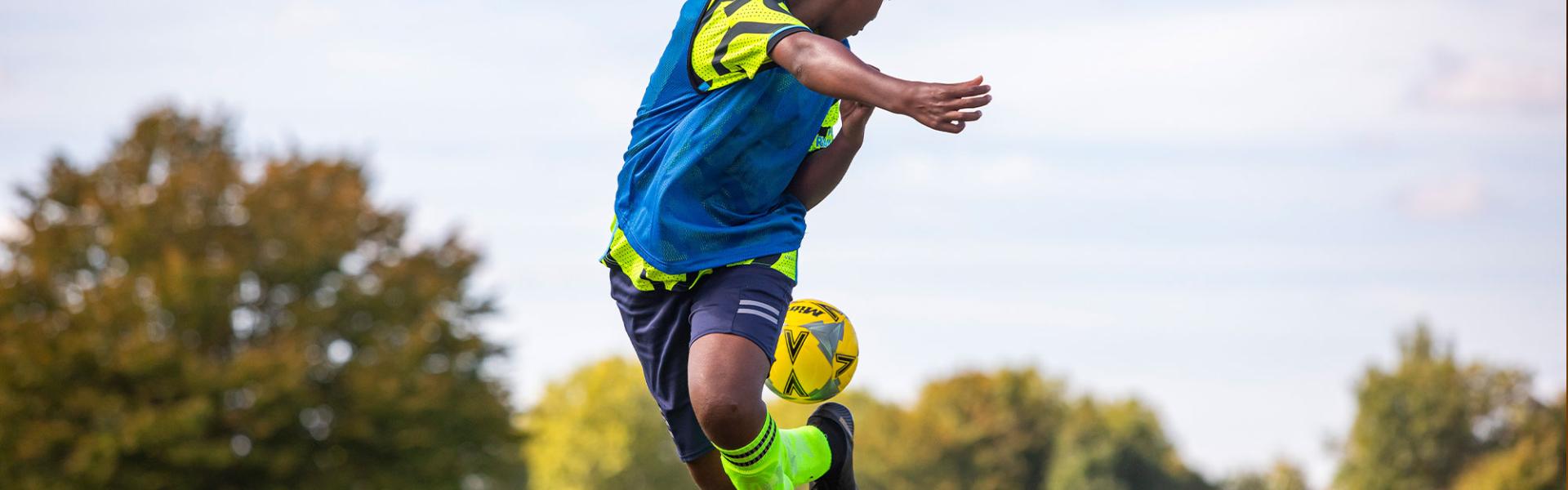 Secondary student playing football